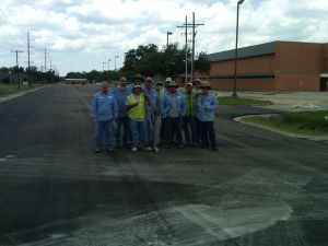 Construction crew posing for photo in road