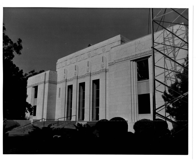 Black and white photo of white building at an angle.